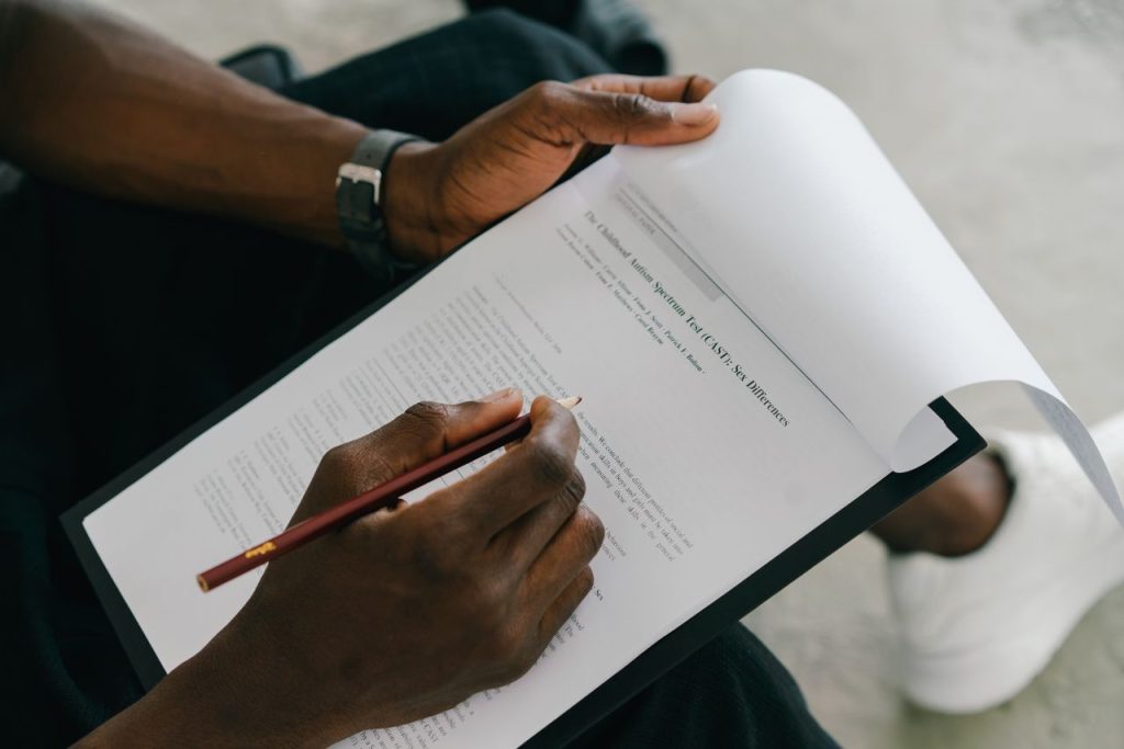 Overcoming Challenges Lessons Every Entrepreneur Must Learn Close-up of a person writing on a psychological assessment form with a pencil.